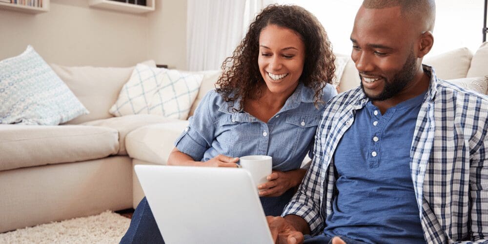 Couple choosing benefits on laptop