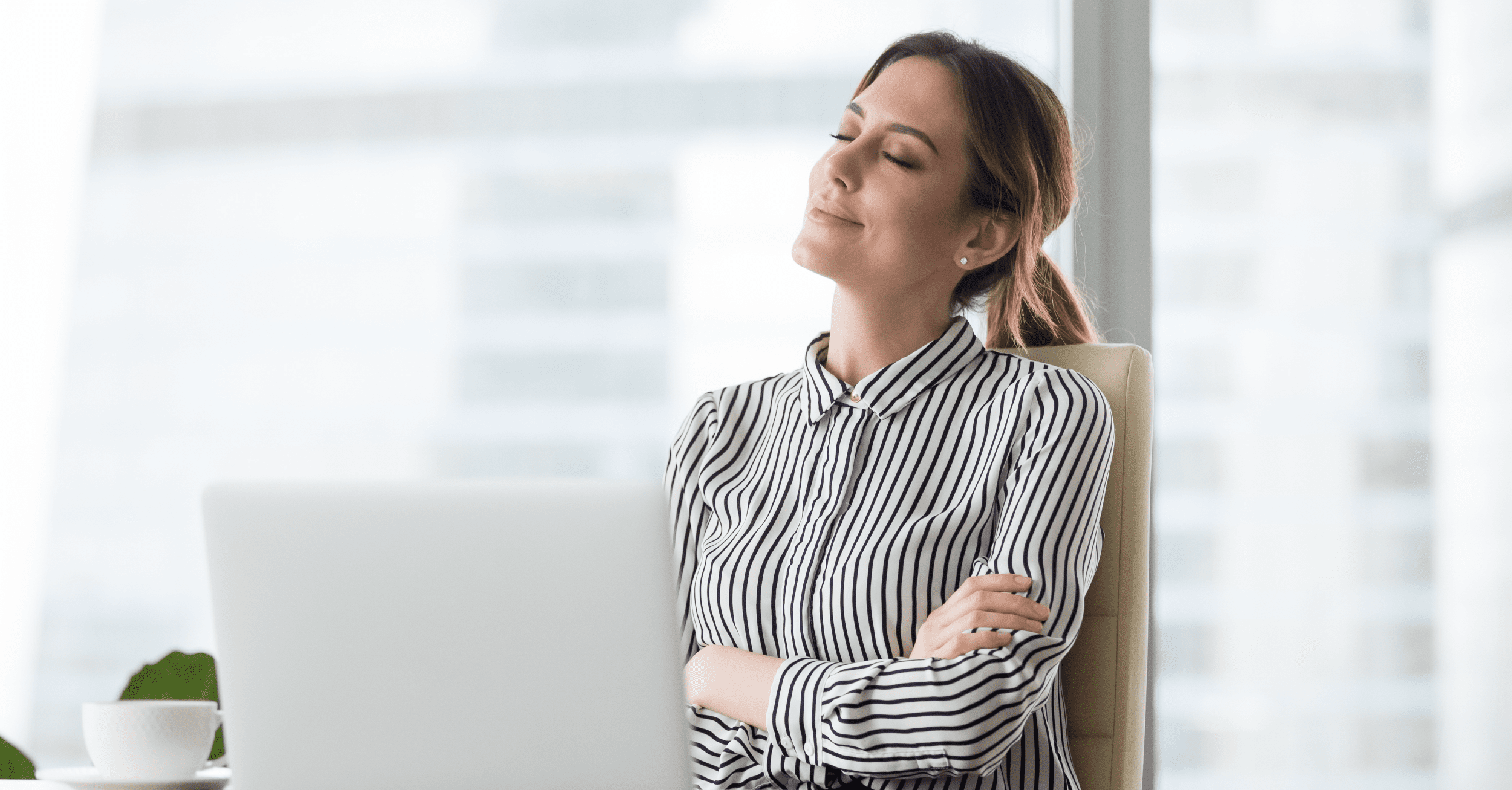 Businesswoman Sitting in Office Chair Relaxing With Eyes Closed