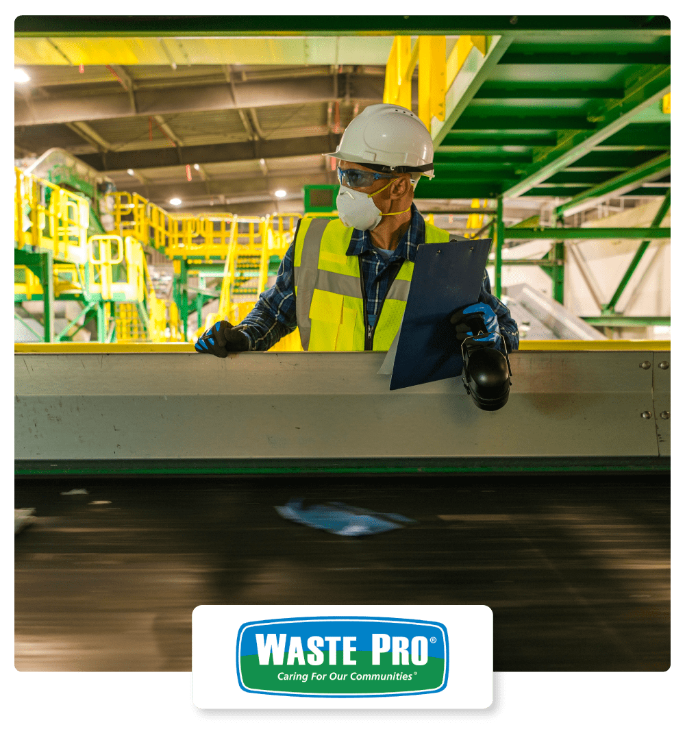 Waste Pro Case Study Hero - Waste Management Worker Checking on Running Trash Material on Conveyor