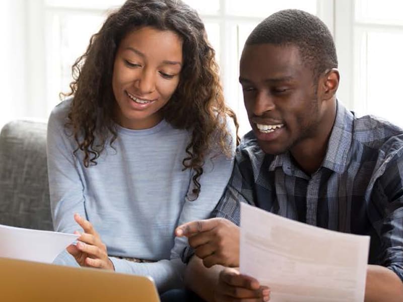 Man and woman reviewing documents at home