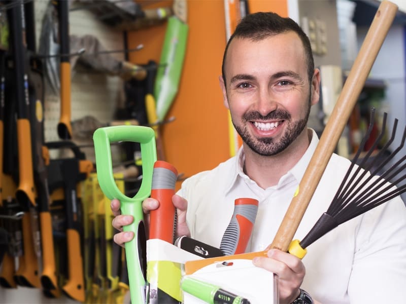 Portrait of Smiling Man Holding Gardening Equipment in Household Tools Department – Resource Thumbnail
